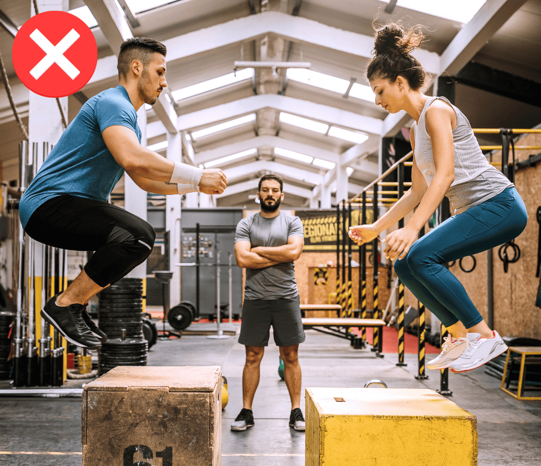 High-intensity fitness class with younger participants, showcasing why high-impact workouts aren’t ideal for women over 50 seeking safe, joint-friendly exercise options.